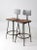 This is a pair of mid-century industrial metal stools. The gray metal stools features pressed wood wide square seats and...