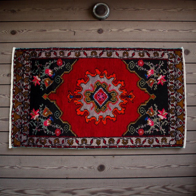 This exquisite hand-knotted vintage Turkish rug brings a vibrant pop of color and rich heritage to any sophisticated...