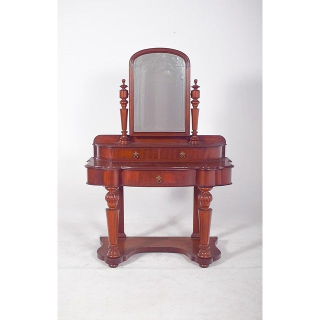 19th century English mahogany dressing table standing on carved column legs and rectangular mirror. Seductive and...