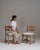 This pair of 1970s oak Mid-Century Modern chairs with upholstered seats from France, made in pale oak with cutout backs...
