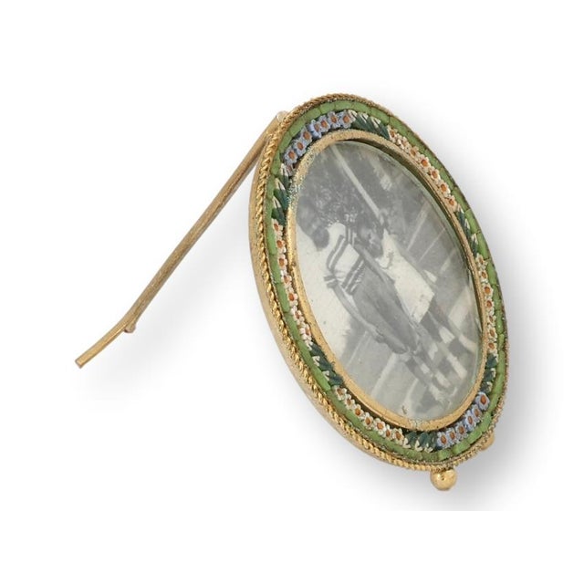 This Italian micromosaic picture frame features finely set glass tesserae arranged in a floral border of jewel tones,...