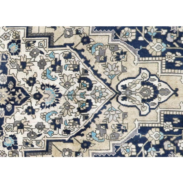 This vintage Turkish Oushak rug, measuring 6'7" x 11'4", is handwoven with wool on a wool foundation in Western Turkey's...