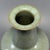 A noble Chinese celadon mallet‑form vase, embodying timeless oriental aesthetic. It is enveloped in serene pale celadon...