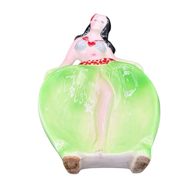 1955 Mid-century Era red and green hula girl ceramic ashtray. The ashtray features a beautifully detailed hula girl...