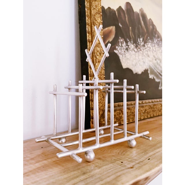 A lovely antique English 4 slice toast rack! This rack has a very interesting shape, it looks very similar to the...