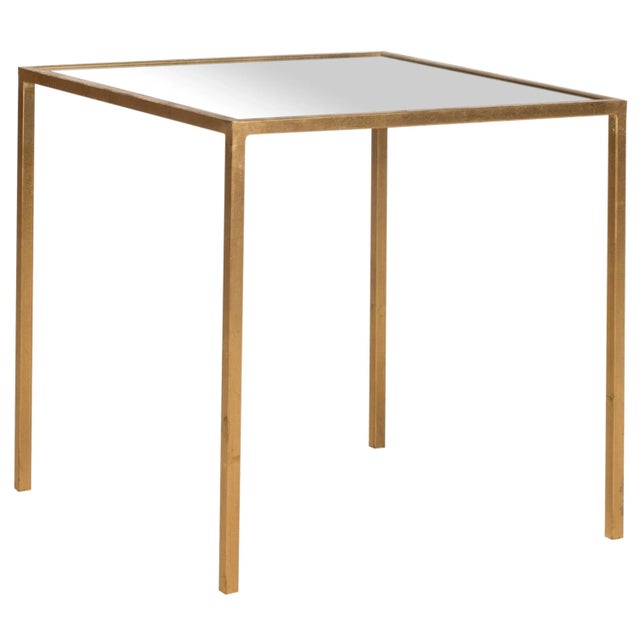 Sophisticated style is often the most simple. Crafted with a gold-leaf iron base and mirrored table top, The Accent Table...