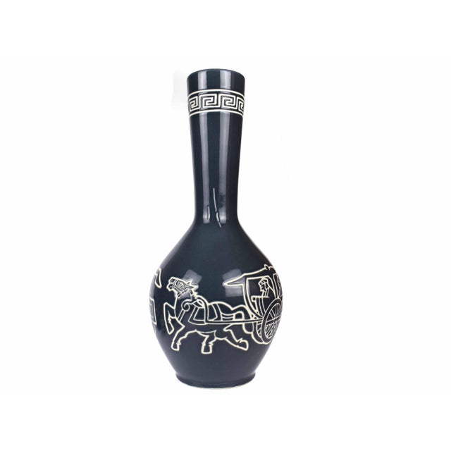 This elegant porcelain vase features a high-contrast Neoclassical design inspired by ancient figure pottery. A detailed...