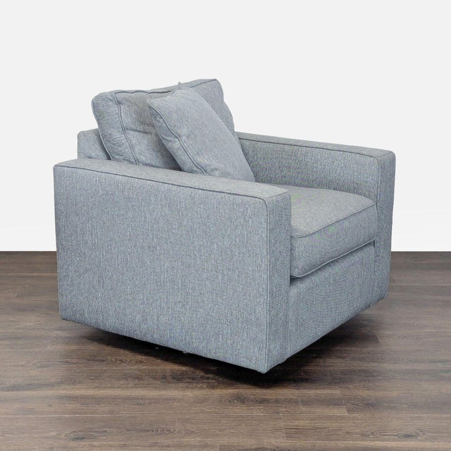 This Room & Board lounge chair features a modern, boxy design and comes in a soft blue upholstery. It offers thick seat...