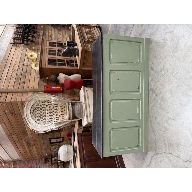This antique retail counter has been fully restored. It features a sage green patinated base and a black patinated top. At...