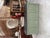 This antique retail counter has been fully restored. It features a sage green patinated base and a black patinated top. At...