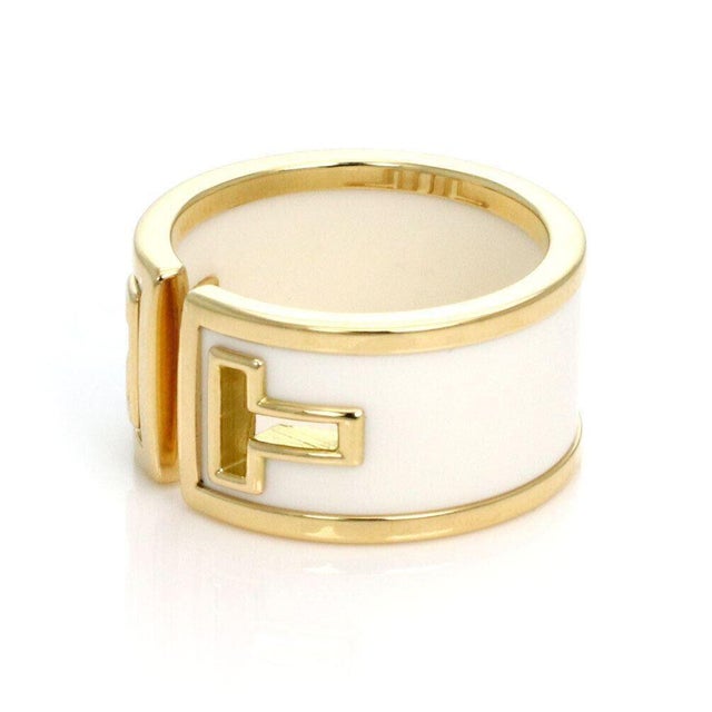 The Tiffany & Co. T Cut White Ceramic 18k Yellow Gold Wide Band Ring in size 6 is a luxurious and elegant piece of vintage...