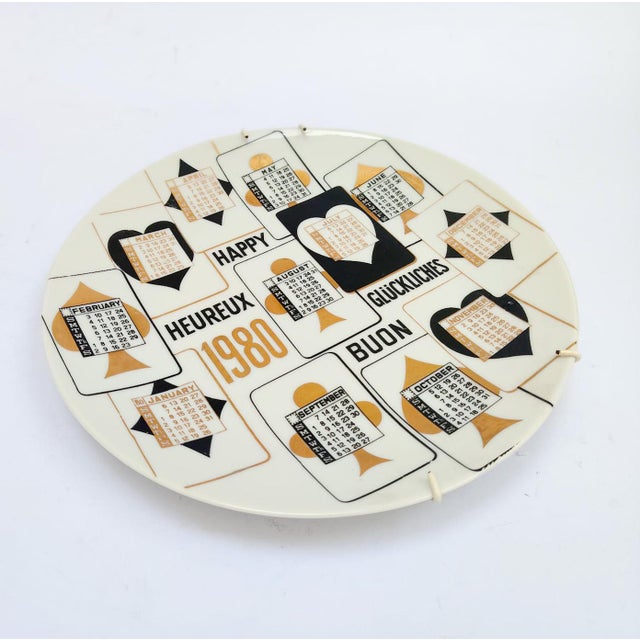 Ceramic Calendar Plate Piero Fornasetti Milano, marked on the back 13th Calendar Plate 1980 White ceramic with gold and...