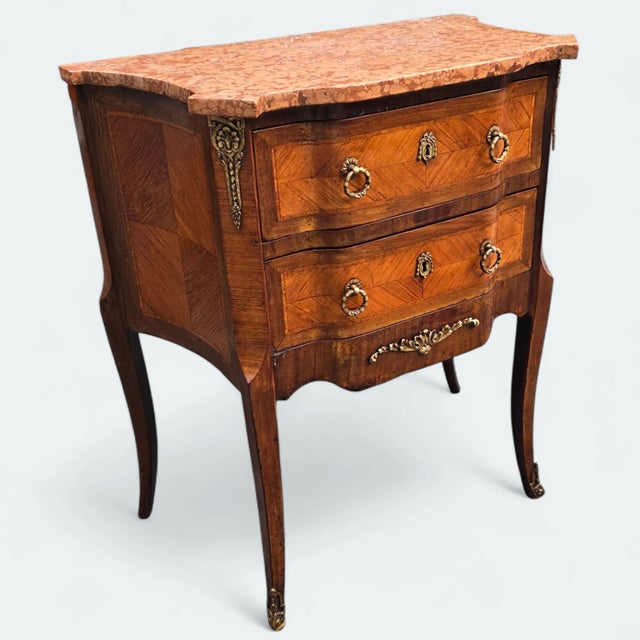 This 19th-Century French Louis XV-Style Parquetry Commode with Breccia Marble Top makes an elegant and refined parisian...
