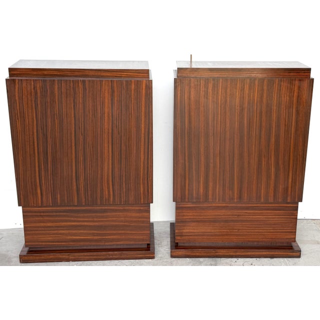 Large Pair of Art Deco Style Zebrawood Pedestals, Late 20th Century This impressive pair of Art Deco–style pedestals is...