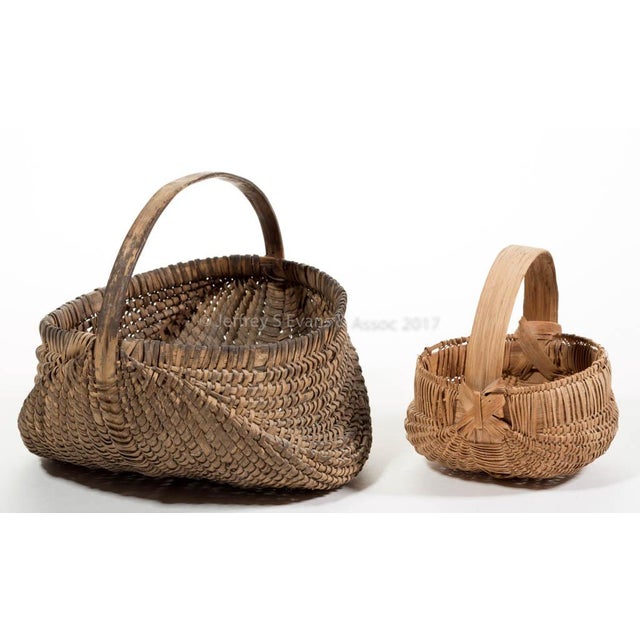 A distinguished pair of hand-woven white oak rib-type baskets from the storied Appalachian basketmaking tradition of...