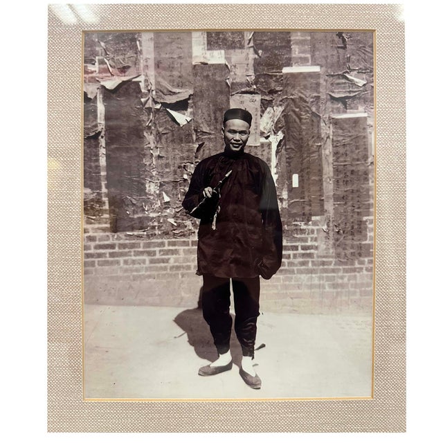 The image shows a framed vintage black-and-white photograph of a Chinese man/Professor standing outdoors against a brick...