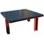 Memphis style ebonized coffee table. Wood top with steel red legs. Measures: 36" square x 16" height.