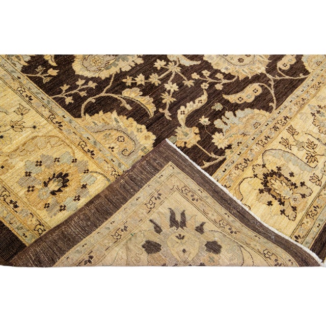 Beautiful oversize Paki Peshawar hand-knotted wool rug with a brown field. This modern rug has gray and golden accents in...