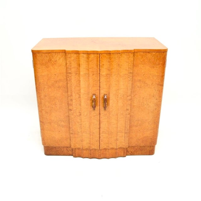 A stunning Art Deco burr walnut cabinet by Harry and Lou Epstein. This was made in England, it dates from the 1930’s. It...