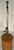 A handsome Mid-Century Modern table lamp featuring a tall cylindrical form wrapped in richly textured natural raffia or...