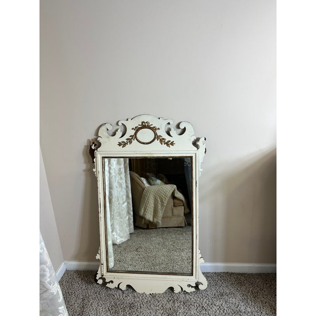 Vintage carved wood wall mirror by Oxford Manufacturing, featuring a richly detailed scrollwork crest and original aged...