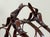 Vintage metal wine rack in the style of Jacques Adnet, featuring an arched form with stitched-leather look detailing,...