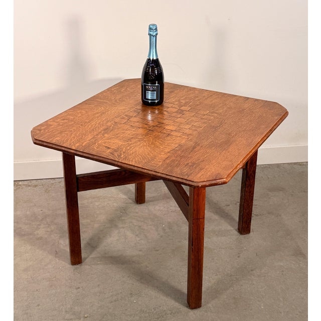 This solid oak game table is a well-executed example of Arts and Crafts furniture, with a quarter-sawn oak top, canted...