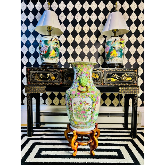 This Chinese porcelain floor vase has a vibrant famille rose decoration with dense floral enamelwork, figural courtyard...