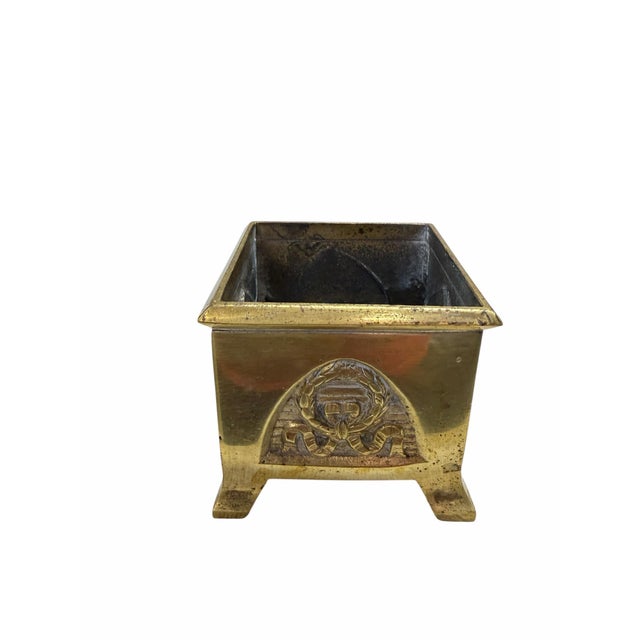 This is a vintage brass footed stamp box, featuring a detailed wreath and ribbon emblem. Uses include but not limited to,...