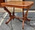 A 19th Century Victorian Rococo Style Walnut Rolling Center Table measuring 35" in width, 25" in depth and 29.5" in...
