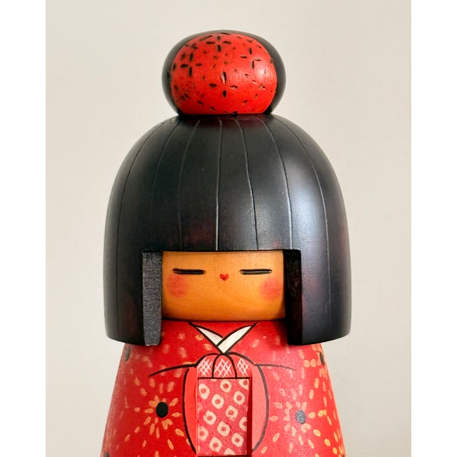 A signed Japanese sosaku (creative) kokeshi by Kazuo Takamizawa, executed in turned and hand-painted wood. This mid-...