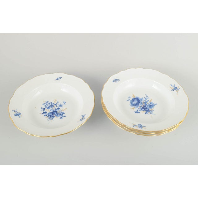 Meissen 4 deep plates, early 20th century. Hand-decorated porcelain with hand-painted blue floral decoration and gilded...