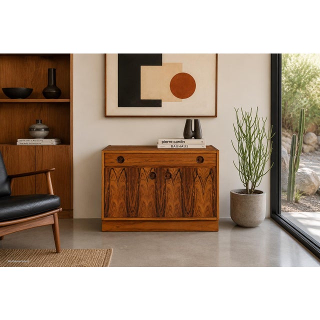 This Swedish modern rosewood small credenza / storage cabinet showcases the exceptional craftsmanship and material...