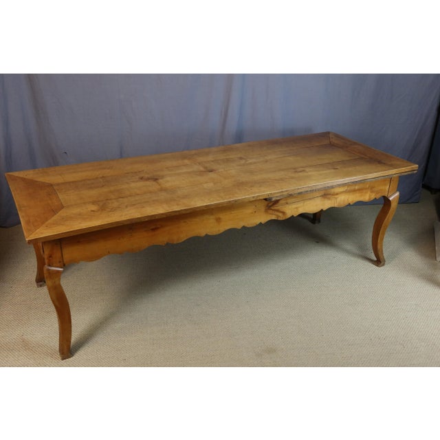 Large cherrywood dining table resting on four cabriole legs in the Louis XV style, early 19th century. It has two drawers...