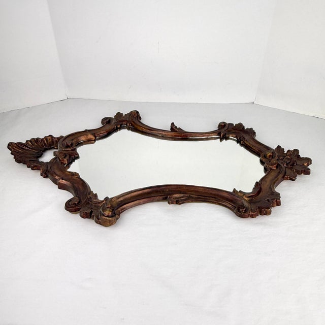 Ornate Rococo style carved wood frame with regal crown detail at the top, floral motif at the bottom and scrollwork on the...