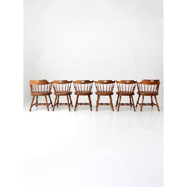 Handsome set of six vintage Dinaire Windsor dining chairs, including two armchairs and four matching side chairs....