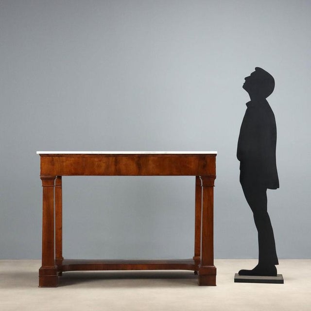 Empire console table in poplar veneered with walnut and crotchet, from Lombardy and dating to the early 19th century. The...