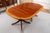 A Regency style double pedestal dining table with a high-gloss French-polished finish, highly figured mahogany top, wide...
