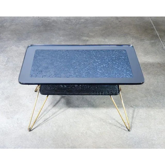 Italian-designed low coffee table , with two tops in thick mirrored glass and golden metal frame origin italy period 1950s...