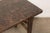 A handsome vintage Chinese writing table crafted from solid elmwood, dating to the first half of the 20th century. The...