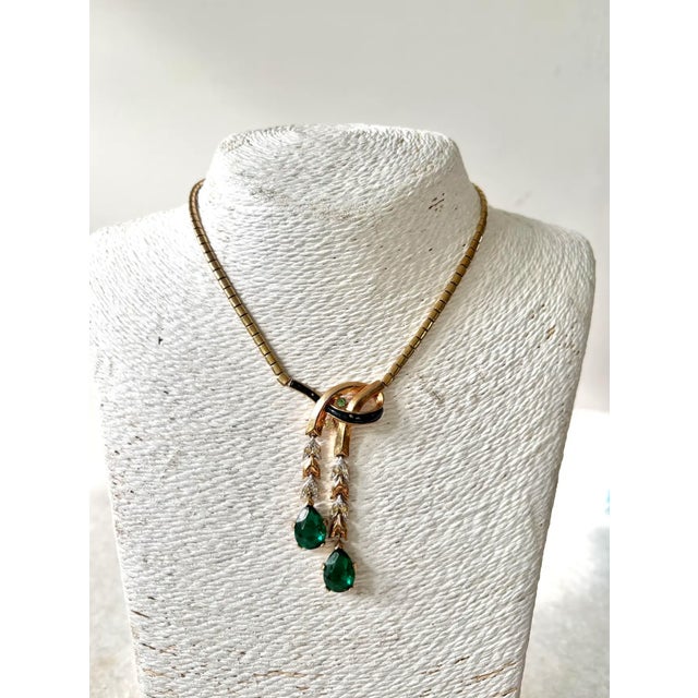 Rare, vintage Crown Trifari gold-toned emerald and clear rhinestone necklace from 1949. Stamped "Trifari Pat Pend"