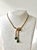 Rare, vintage Crown Trifari gold-toned emerald and clear rhinestone necklace from 1949. Stamped "Trifari Pat Pend"
