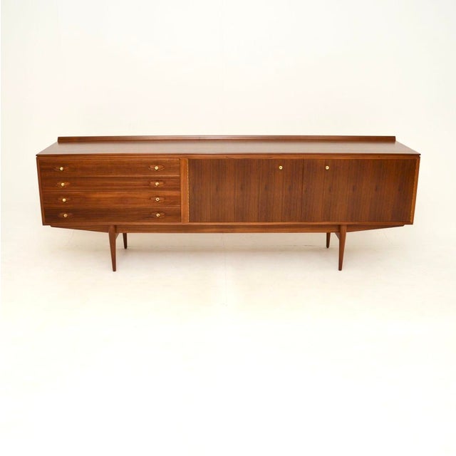 A superb vintage walnut Hamilton sideboard by Robert Heritage for Archie Shine. This was made in England, it dates from...
