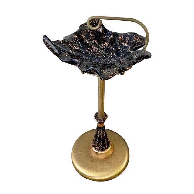 Bring classic mid-century style to your space with this striking vintage standing ashtray. This piece features a...