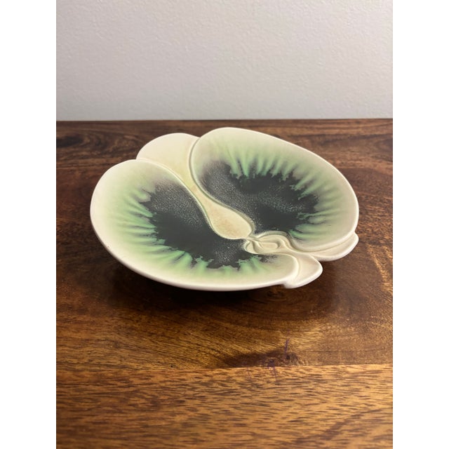A sculptural 1970s porcelain orchid bowl by Oregon studio potters Alan and Brenda Newman. The organic botanical form is...