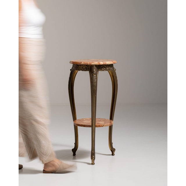 Marble-top gueridon table in Deep Ebony Black. Finished in deep ebony black, this marble-top gueridon table is...