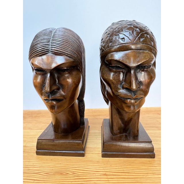 Stylized mid-century carved hardwood heads by Silva (likely A. Silva). Angular Art-Deco planes, one with geometric cap,...