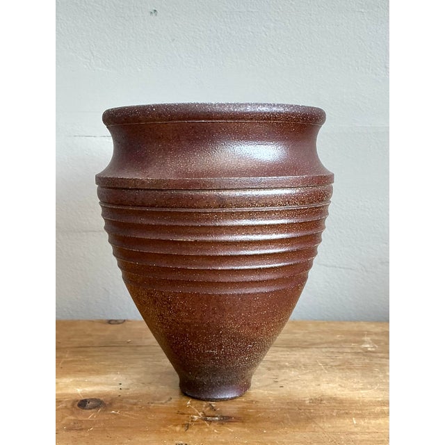 This striking vintage studio pottery vase is a masterclass in architectural form and tactile beauty. Hand-thrown with a...