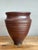 This striking vintage studio pottery vase is a masterclass in architectural form and tactile beauty. Hand-thrown with a...