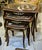Elegant Rococo style nesting tables featuring a luxurious set of three accent tables topped with sophisticated black...